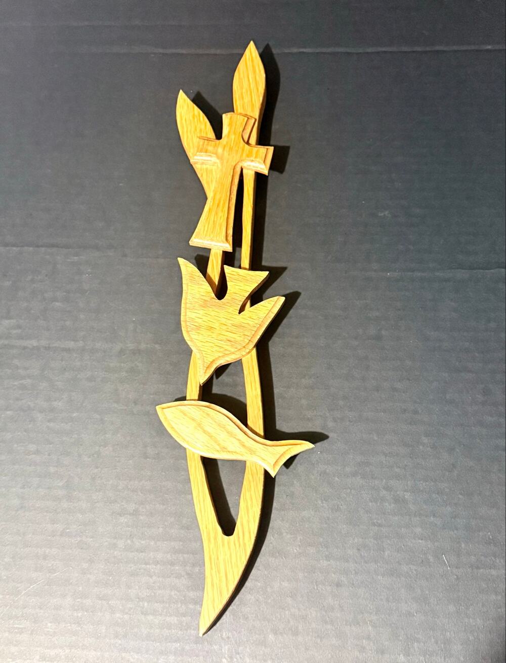 hand-cut wooden wall hanging featuring a layered cross dove fish symbol religion